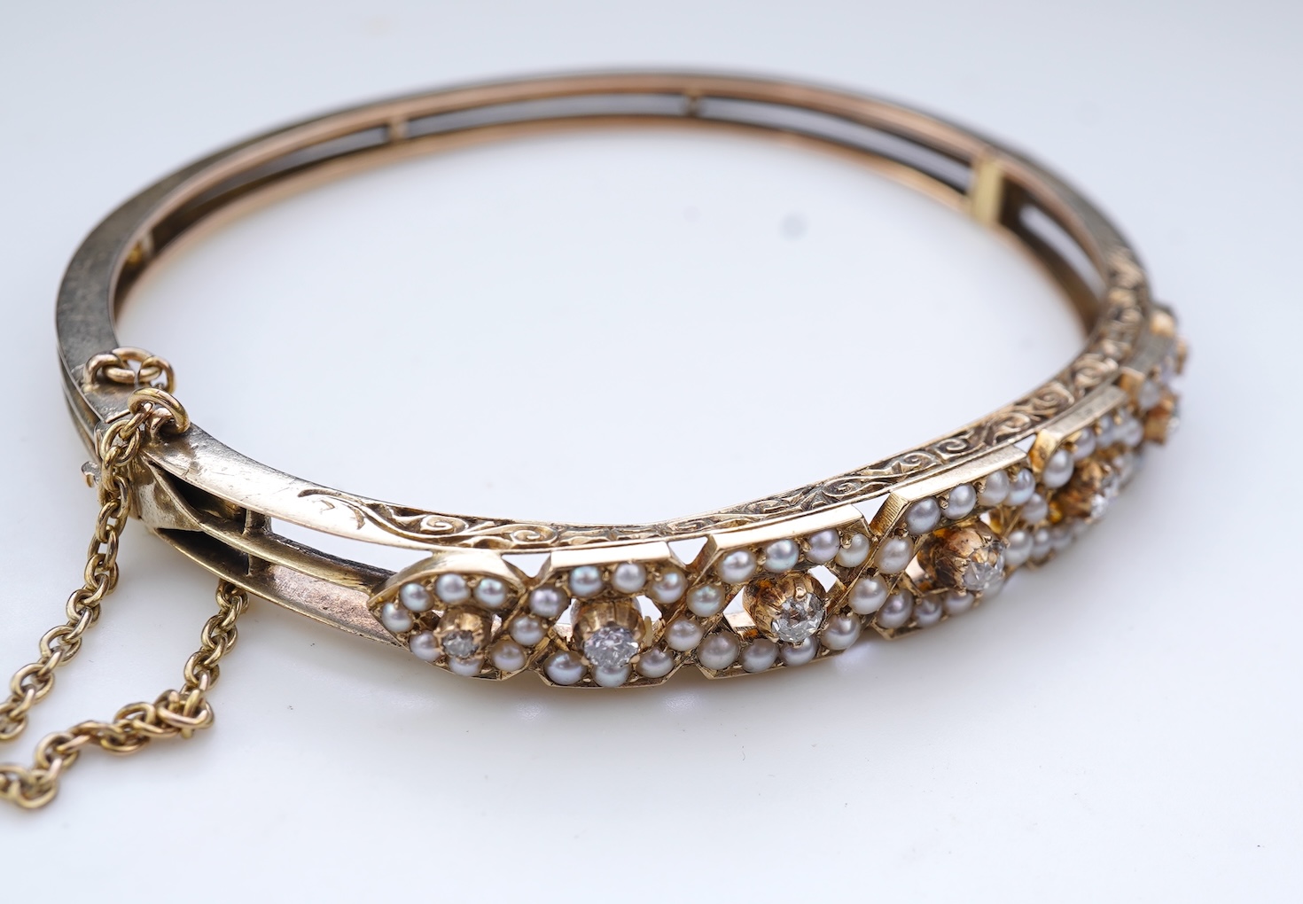 An Edwardian seed pearl and diamond bangle, early 20th century